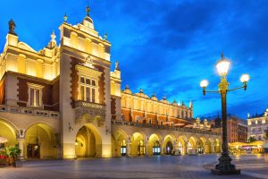 Jewish Heritage in Central Europe, 14 days/13 nights. Illuminated palace on old town square at night Krakow, Poland. Jewish Heritage in Central Europe