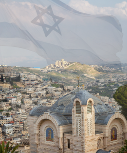 Israeli flag with the Star of David waving over a hillside city, with a domed church in the foreground. - Aufgang Travel