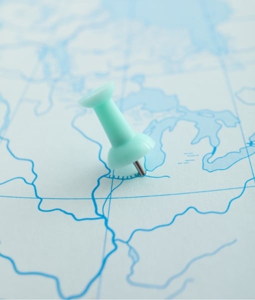 Mint-green pushpin marking a location on a blue map surface. - Aufgang Travel